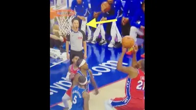 NBA referee Evan Scott watching Joel Embiid