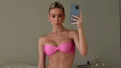 Hayden Hopkins holds up her phone