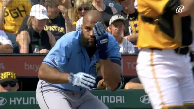Rays infielder Amed Rosario covering his face