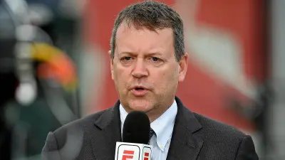 Buster Olney holding a microphone
