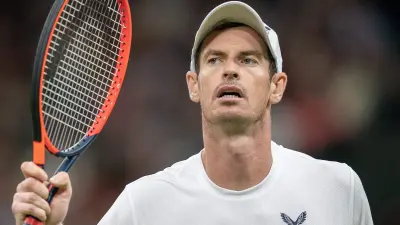 Andy Murray holds up his racquet