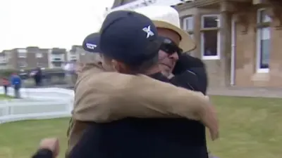 Xander Schauffele and his father share a hug
