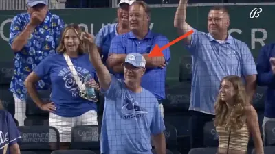 A Royals fan pointing at Bobby Witt Jr.