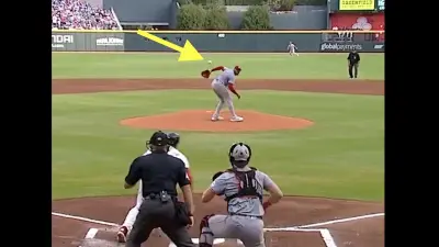 Reds pitcher Hunter Greene making a behind-the-back play