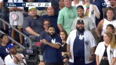 Yankees fan loading up to throw back Rafael Devers' home run ball
