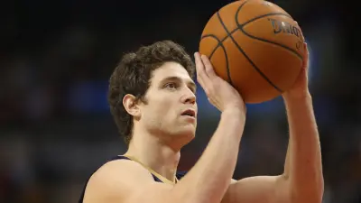 Jimmer Fredette shooting a ball