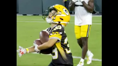 A young Packers fan makes a catch