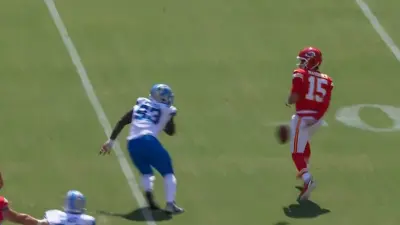 Patrick Mahomes throws the ball behind his back