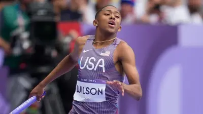 Quincy Wilson running with a baton