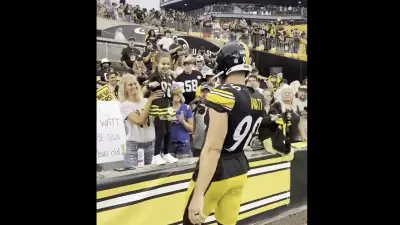 TJ Watt giving his glove to a young Steelers fan