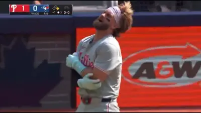 Bryce Harper holding his elbow