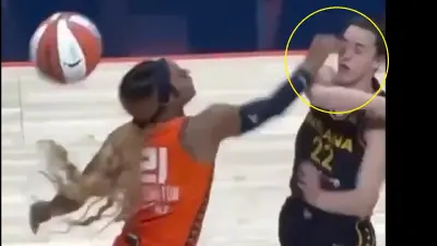 DiJonai Carrington touches Caitlin Clark's eye