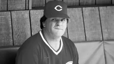 Pete Rose sitting in the Reds' dugout