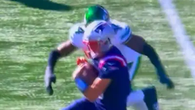 Drake Maye gets hit high by a defender