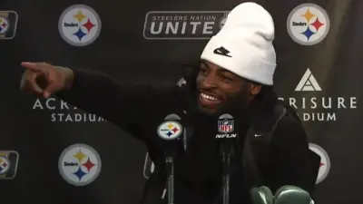 Najee Harris points during a press conference