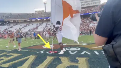 Texas linebacker Barryn Sorrell plants a flag on Baker Mayfield's Oklahoma jersey