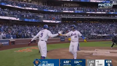 Pete Alonso touches a teammate