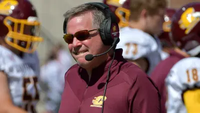Jim McElwain wearing a headset