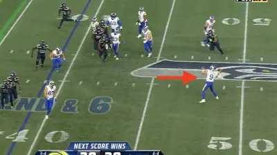 Rams QB Matthew Stafford throwing next to the Seahawks' midfield logo
