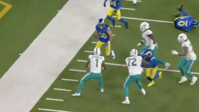 Dolphins QB Tua Tagovailoa preparing to make a tackle against the Rams