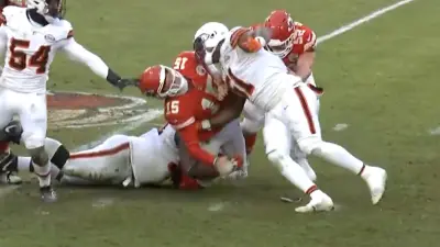 Patrick Mahomes takes a hit from two defenders