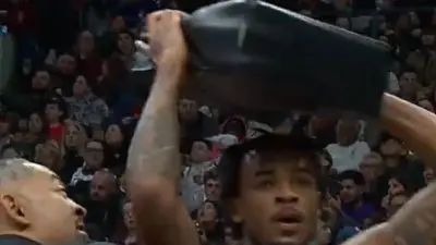 Nic Claxton holding a seat cushion over his head