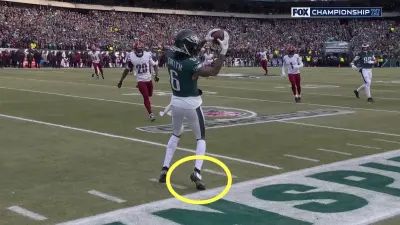DeVonta Smith catches a pass at the sideline