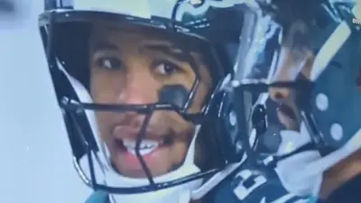 Saquon Barkley says something to Jalen Hurts