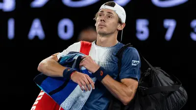 Alex de Minaur holding his bag