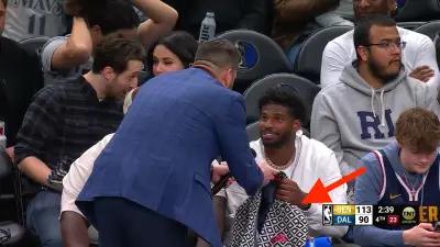 Deion Sanders' son Shedeur receiving a blazer from Greg Anthony