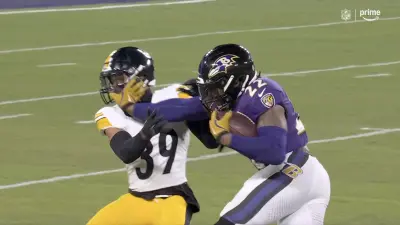 Derrick Henry using a stiff-arm to push down Minkah Fitzpatrick