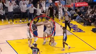 Draymond Green and Zach Edey pushing each other
