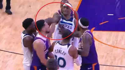 Jaden McDaniels pointing at Devin Booker