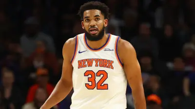 Karl-Anthony Towns in a Knicks jersey looking on