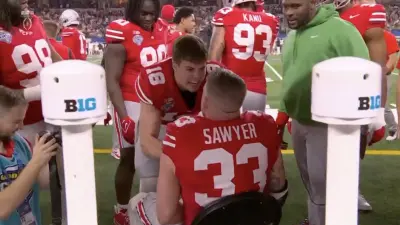 Ohio State players Will Howard and Jack Sawyer face to face