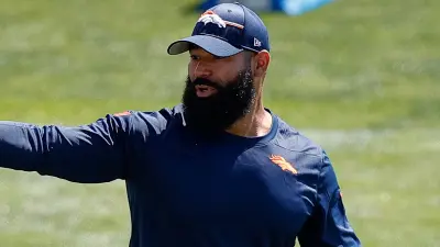Michael Wilhoite points on the practice field