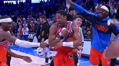 Aaron Wiggins being mobbed by teammates