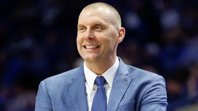 Mark Pope smiling during a game