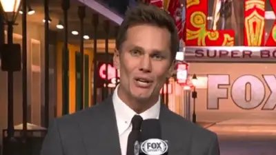 Tom Brady holds a mic