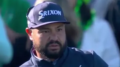 JJ Spaun watches a ball