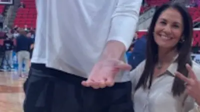 Tracy Wolfson stands next to Olivier Rioux