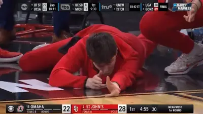 A St Johns player celebrates like a sniper on the bench