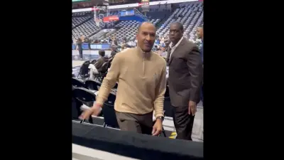 Nico Harrison looking at a Mavericks fan