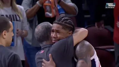 Houston coach Kelvin Sampson hugs Gonzaga guard Khalif Battle during March Madness