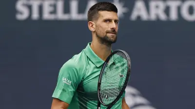 Novak Djokovic holds a racquet