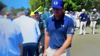 Jordan Spieth gives someone a cup check