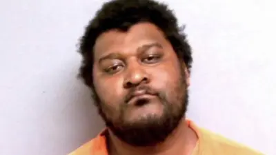 Justin Blackmon poses for a mugshot
