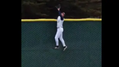 KW Quilici climbs a fence