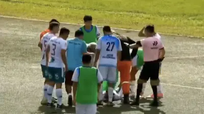 A soccer player lays on the turf after a collision