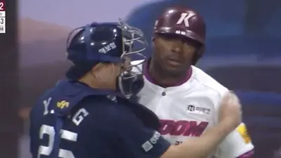 Yasiel Puig is held back from charging the mound